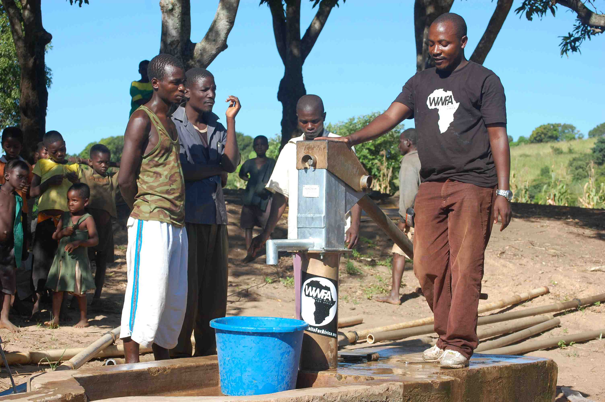 WWFA team member stands by and says a few words to thank the donors, and instruct the community in continued maintenance and care for the borehole.
