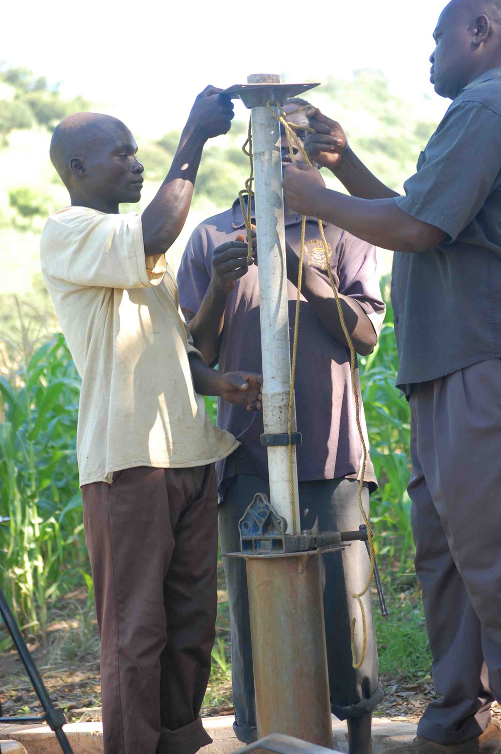 Community members taking part in fixing the borehole.